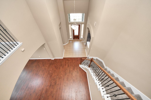 30041 Willow Walk Ln, Brookshire, TX 77423 - entryway with stairs, arched walkways, wood finished floors, a chandelier, and a high ceiling