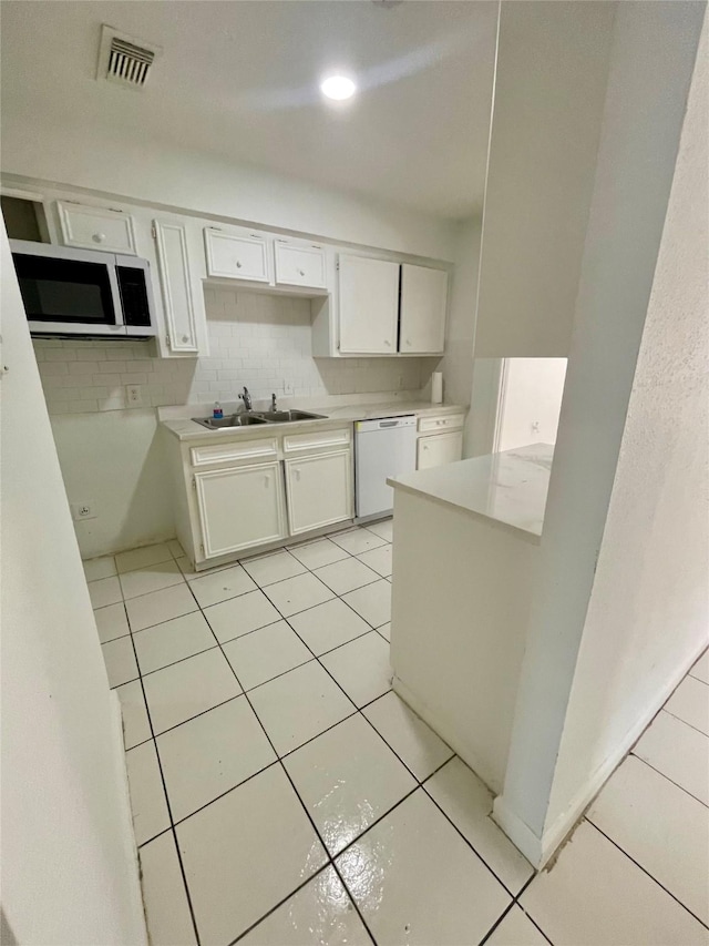 4202 Boone Rd, Houston, TX 77072 - kitchen featuring white appliances, light tile patterned flooring, white cabinetry, light countertops, and tasteful backsplash