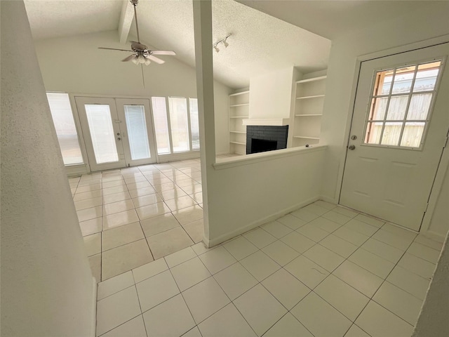 4202 Boone Rd, Houston, TX 77072 - unfurnished living room with light tile patterned flooring, a brick fireplace, a textured ceiling, built in shelves, and ceiling fan
