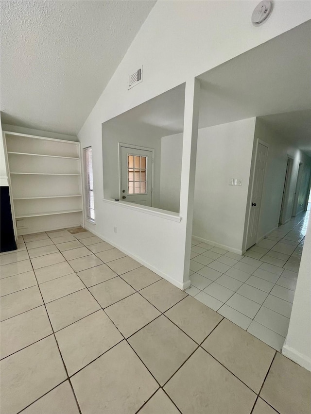 4202 Boone Rd, Houston, TX 77072 - spare room with a textured ceiling, light tile patterned floors, and high vaulted ceiling