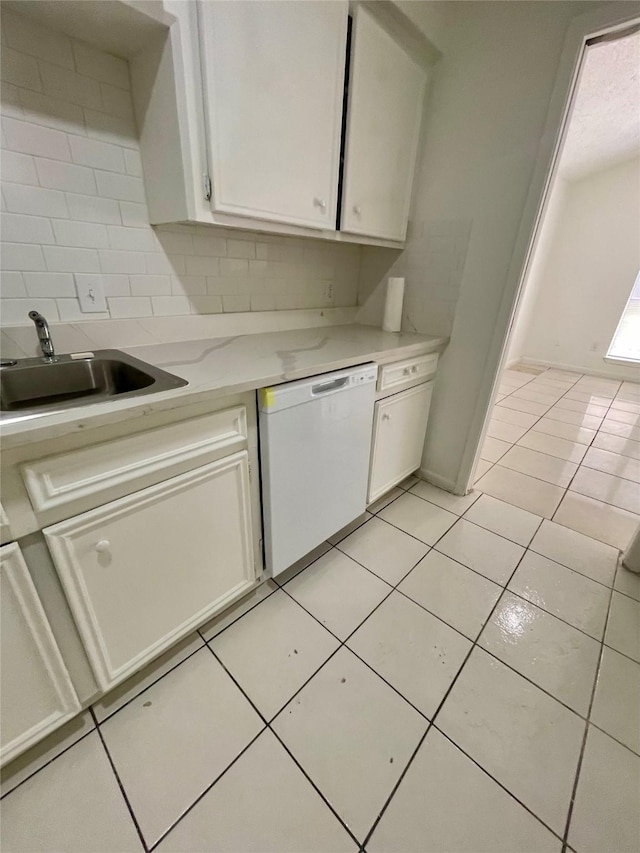 4202 Boone Rd, Houston, TX 77072 - kitchen featuring white dishwasher, white cabinets, light tile patterned floors, and backsplash