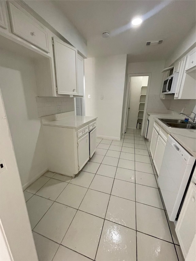 4202 Boone Rd, Houston, TX 77072 - kitchen featuring light countertops, white appliances, white cabinetry, and light tile patterned flooring