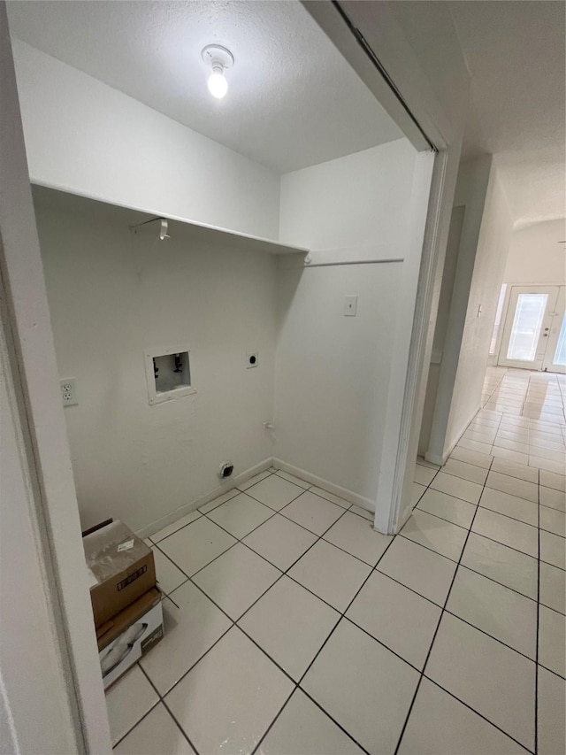 4202 Boone Rd, Houston, TX 77072 - washroom featuring hookup for an electric dryer, washer hookup, light tile patterned flooring, and a textured ceiling