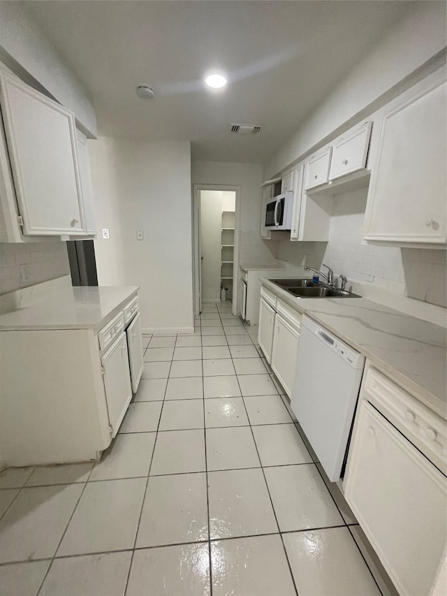 4202 Boone Rd, Houston, TX 77072 - kitchen with white appliances, white cabinetry, light tile patterned flooring, light countertops, and tasteful backsplash