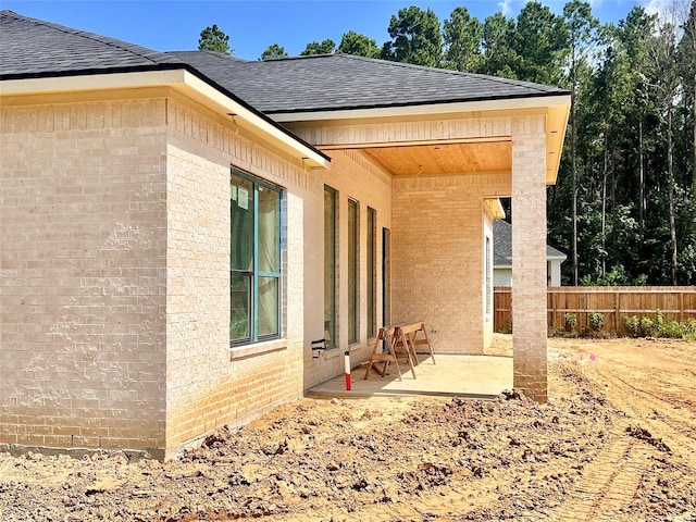 1162 Rd 6604, Dayton, TX 77535 - rear view of house with roof with shingles, a patio area, and brick siding