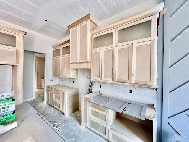 1162 Rd 6604, Dayton, TX 77535 - kitchen with glass insert cabinets, light brown cabinets, concrete floors, and light countertops