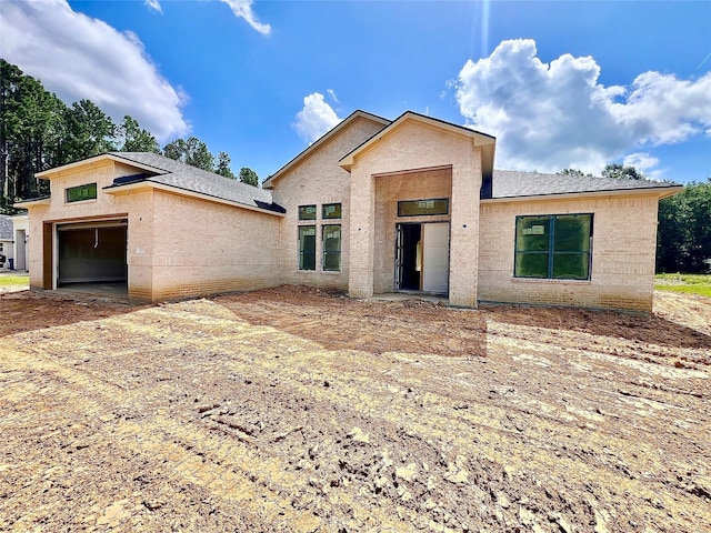 1162 Rd 6604, Dayton, TX 77535 - view of front facade with a garage, brick siding, and a shingled roof