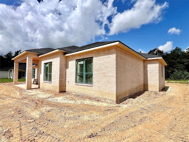 1162 Rd 6604, Dayton, TX 77535 - view of property exterior featuring a patio area and roof with shingles
