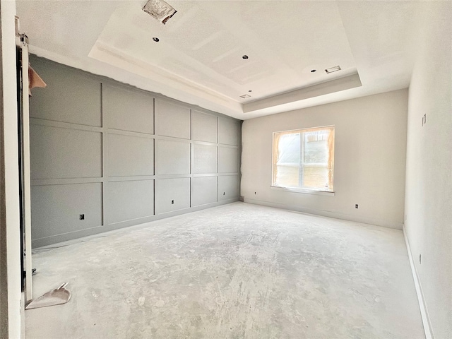 1162 Rd 6604, Dayton, TX 77535 - spare room featuring a raised ceiling, unfinished concrete floors, and a decorative wall