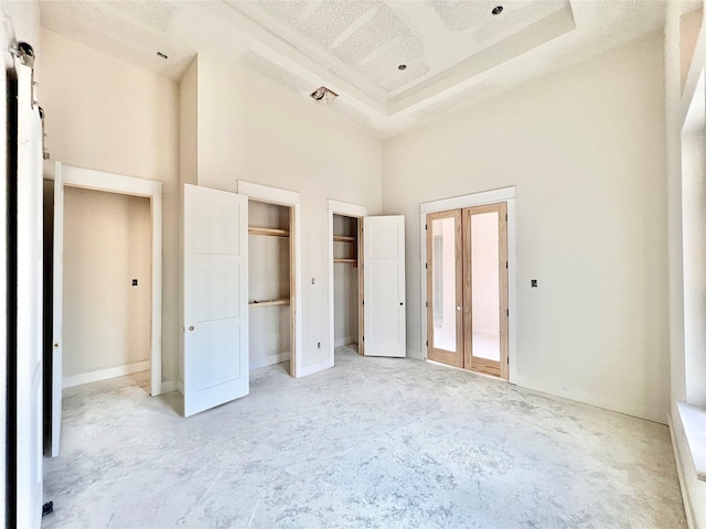 1162 Rd 6604, Dayton, TX 77535 - unfurnished bedroom featuring a towering ceiling and two closets