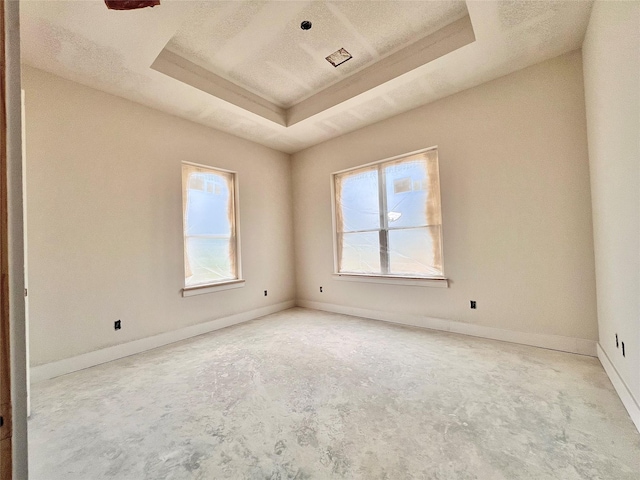1162 Rd 6604, Dayton, TX 77535 - unfurnished room featuring unfinished concrete floors, a raised ceiling, and plenty of natural light