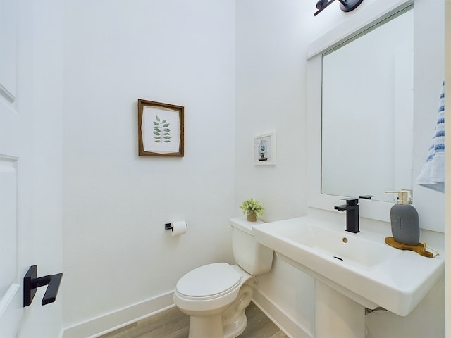 2704 Jensen Creek Ln, Houston, TX 77026 - half bathroom featuring wood finished floors and toilet