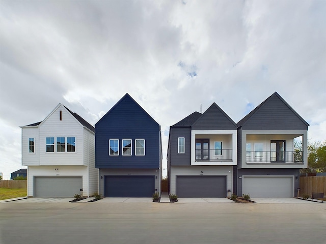 2704 Jensen Creek Ln, Houston, TX 77026 - view of property with an attached garage, a balcony, and driveway