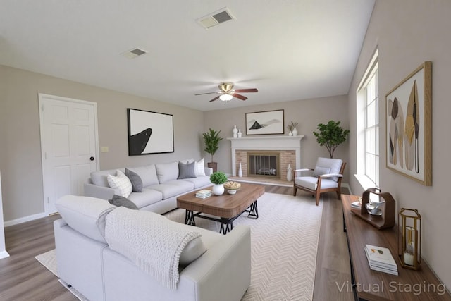 15918 Pinyon Creek Dr, Houston, TX 77095 - living room with wood finished floors, ceiling fan, and a brick fireplace