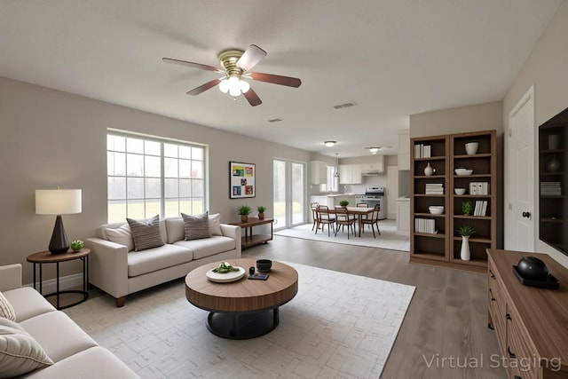 15918 Pinyon Creek Dr, Houston, TX 77095 - living area featuring ceiling fan and light wood-type flooring