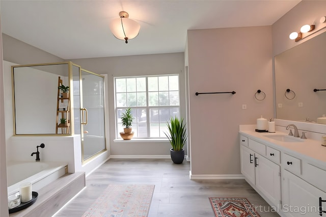 15918 Pinyon Creek Dr, Houston, TX 77095 - bathroom featuring vanity, wood finished floors, a bath, and a stall shower