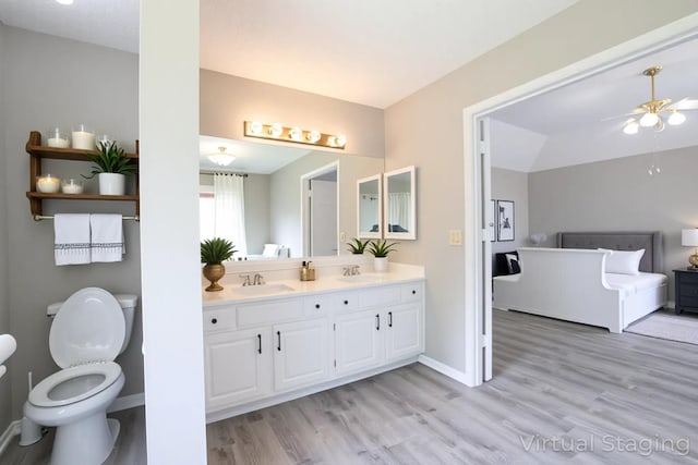 15918 Pinyon Creek Dr, Houston, TX 77095 - bathroom with double vanity, wood finished floors, and ceiling fan