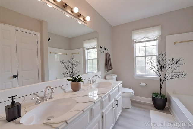 15918 Pinyon Creek Dr, Houston, TX 77095 - full bathroom featuring double vanity, plenty of natural light, wood finished floors, and a bath
