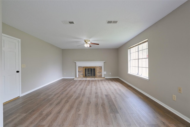 15918 Pinyon Creek Dr, Houston, TX 77095 - unfurnished living room with ceiling fan, wood finished floors, and a glass covered fireplace