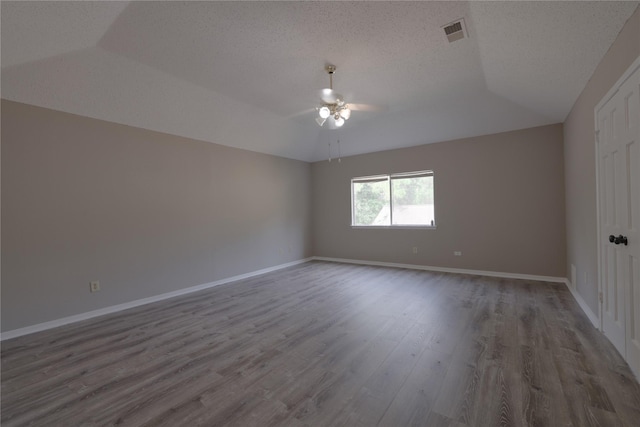 15918 Pinyon Creek Dr, Houston, TX 77095 - unfurnished room with wood finished floors, a ceiling fan, vaulted ceiling, and a textured ceiling