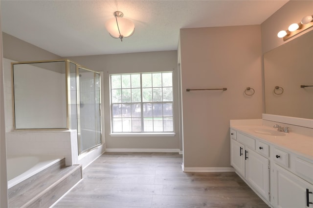 15918 Pinyon Creek Dr, Houston, TX 77095 - bathroom with vanity, a bath, wood finished floors, and a shower with shower door