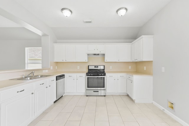 1611 Hade Meadow Ln, Houston, TX 77073 - kitchen with appliances with stainless steel finishes, light countertops, white cabinets, lofted ceiling, and under cabinet range hood