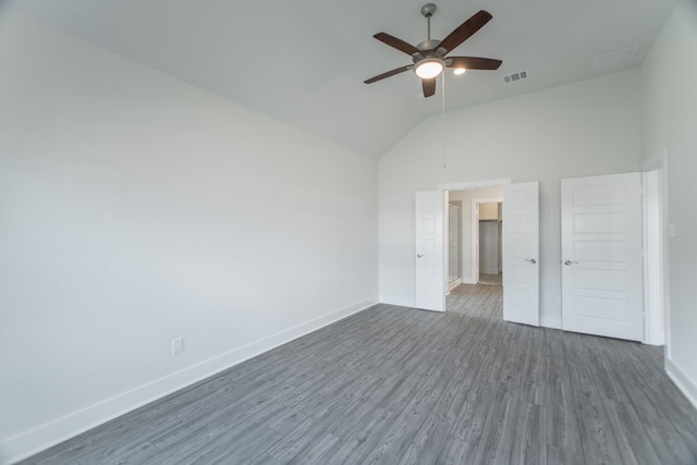 10663 Whitejacket, Conroe, TX 77385 - unfurnished bedroom with dark wood-style floors, high vaulted ceiling, and a ceiling fan
