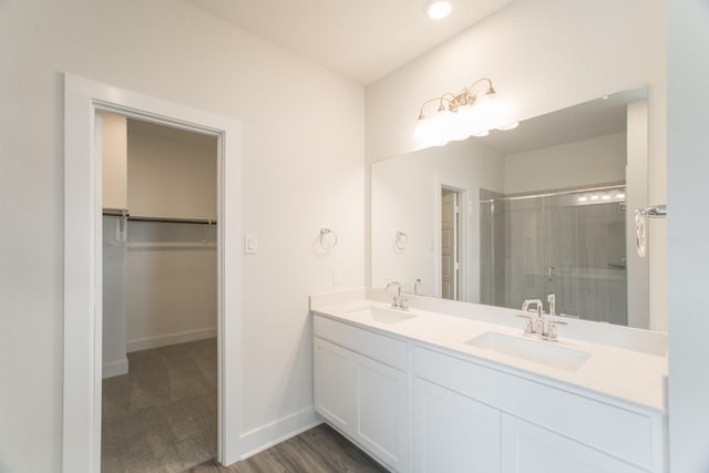 10663 Whitejacket, Conroe, TX 77385 - bathroom featuring a shower stall, a spacious closet, and double vanity