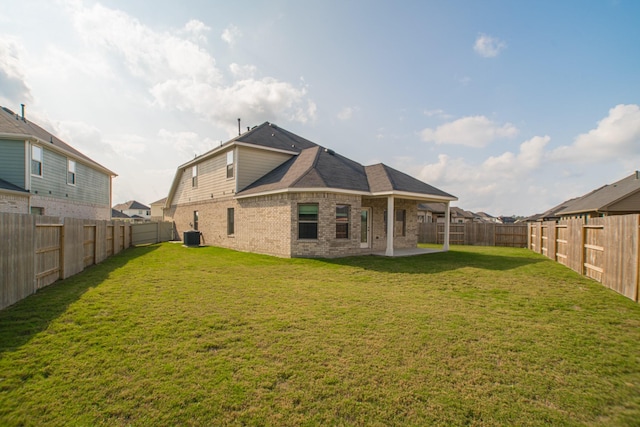 10663 Whitejacket, Conroe, TX 77385 - rear view of house featuring brick siding, a fenced backyard, and a patio