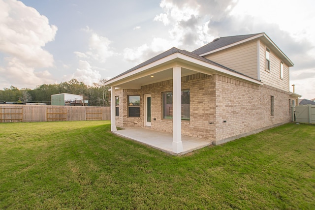 10663 Whitejacket, Conroe, TX 77385 - rear view of property with a patio, brick siding, a fenced backyard, and a gate