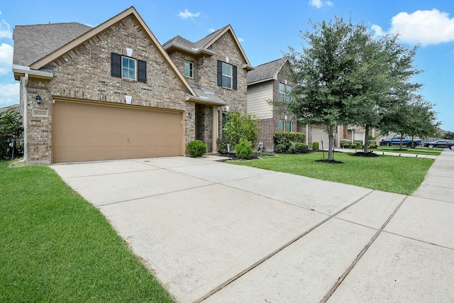 10219 Kentington Oak Dr, Humble, TX 77396 - traditional-style house with brick siding, driveway, a front yard, and roof with shingles