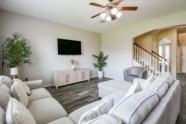 10219 Kentington Oak Dr, Humble, TX 77396 - living room featuring a ceiling fan, arched walkways, dark wood finished floors, and stairway