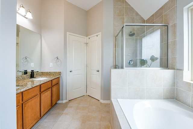 10219 Kentington Oak Dr, Humble, TX 77396 - bathroom featuring a bath, a stall shower, vanity, lofted ceiling, and tile patterned flooring