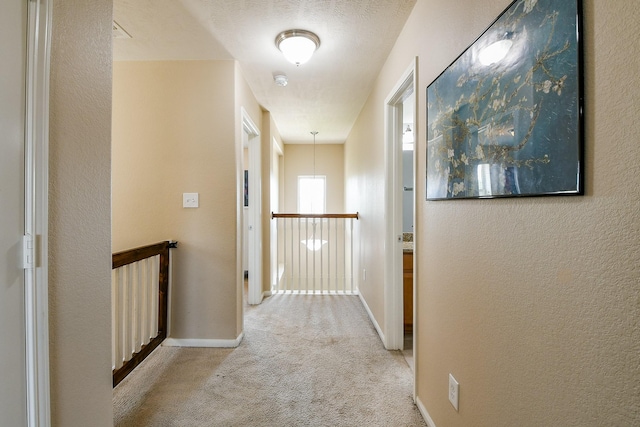 10219 Kentington Oak Dr, Humble, TX 77396 - corridor featuring light carpet, an upstairs landing, and a textured wall
