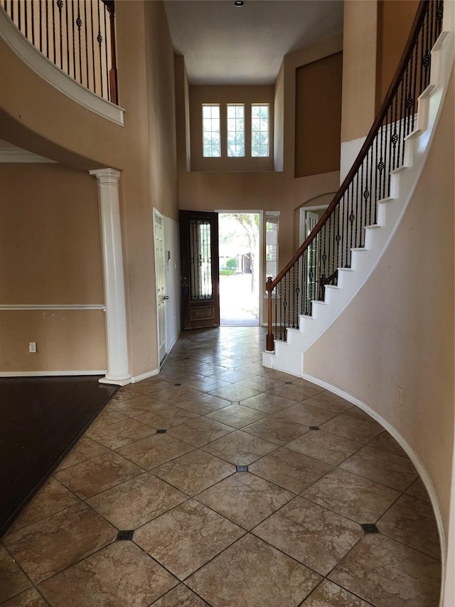 9510 Gentry Shadows Ln, Humble, TX 77396 - foyer entrance featuring a high ceiling, stairs, and stone tile flooring