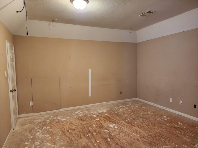 9510 Gentry Shadows Ln, Humble, TX 77396 - empty room with lofted ceiling and a textured ceiling