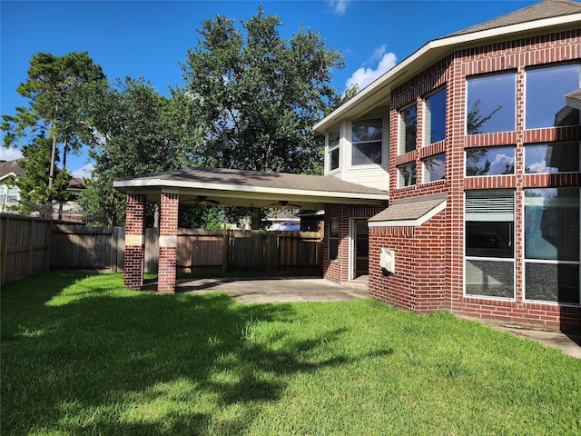 9510 Gentry Shadows Ln, Humble, TX 77396 - back of property featuring brick siding and a ceiling fan