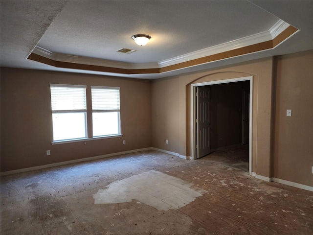 9510 Gentry Shadows Ln, Humble, TX 77396 - empty room with a tray ceiling, crown molding, and a textured ceiling
