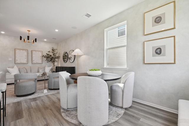 16614 Bobal Path, Houston, TX 77909 - dining area featuring wood finished floors, a chandelier, and recessed lighting