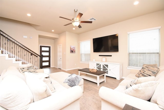 7011 Golden Groundsel Dr, Katy, TX 77493 - living room featuring ceiling fan, light wood-style flooring, recessed lighting, and stairway