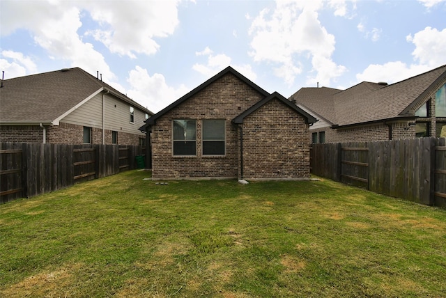 7011 Golden Groundsel Dr, Katy, TX 77493 - back of property featuring brick siding and a fenced backyard