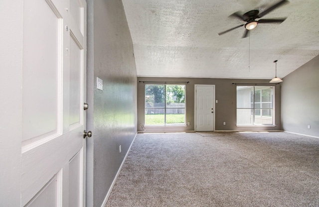 906 Dixie Dr, League City, TX 77573 - unfurnished living room with a textured ceiling, ceiling fan, and carpet flooring