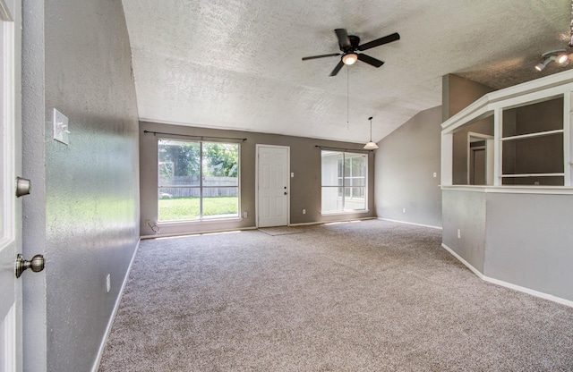 906 Dixie Dr, League City, TX 77573 - empty room featuring a textured ceiling, carpet floors, ceiling fan, and lofted ceiling