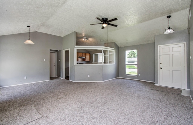 906 Dixie Dr, League City, TX 77573 - unfurnished living room with vaulted ceiling, a ceiling fan, carpet floors, and a textured ceiling