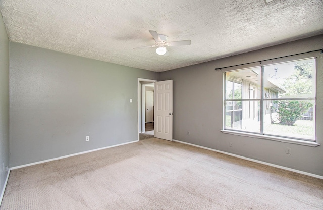 906 Dixie Dr, League City, TX 77573 - unfurnished room featuring light colored carpet, ceiling fan, and a textured ceiling