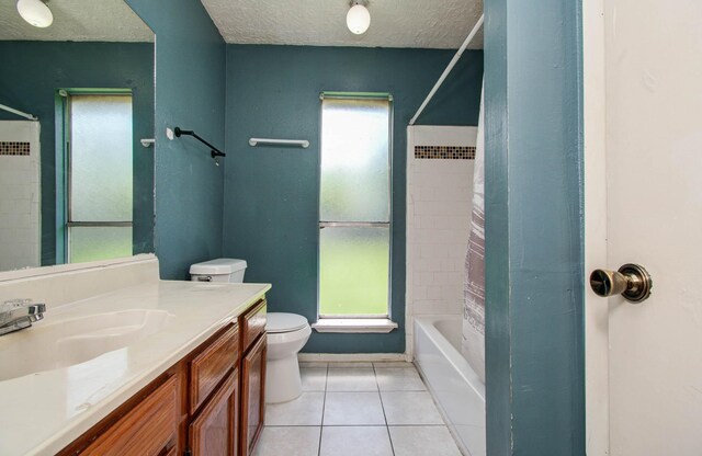 906 Dixie Dr, League City, TX 77573 - bathroom with tile patterned floors, vanity, a textured ceiling, and shower / tub combo