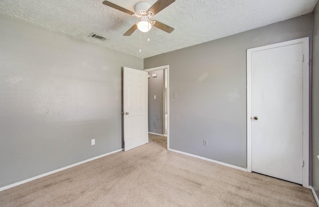 906 Dixie Dr, League City, TX 77573 - unfurnished bedroom with carpet flooring, a textured ceiling, and a ceiling fan