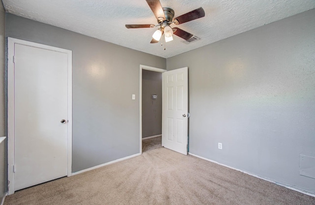 906 Dixie Dr, League City, TX 77573 - unfurnished bedroom featuring carpet floors, a textured ceiling, and a ceiling fan