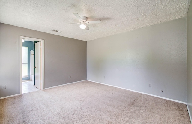 906 Dixie Dr, League City, TX 77573 - unfurnished room with light carpet, ceiling fan, and a textured ceiling