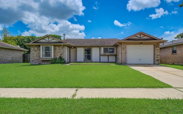 906 Dixie Dr, League City, TX 77573 - view of front of house featuring concrete driveway, a garage, a front lawn, and brick siding
